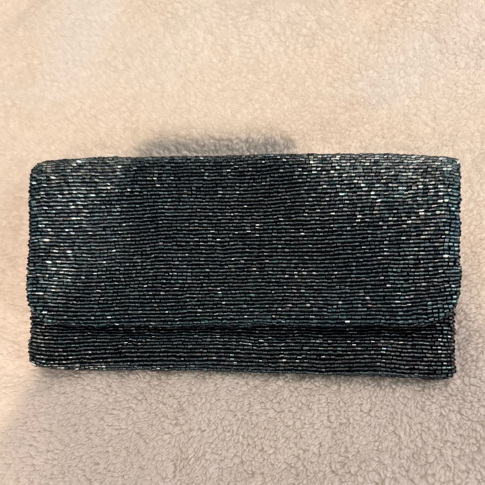 Teal beaded zippered clutch.